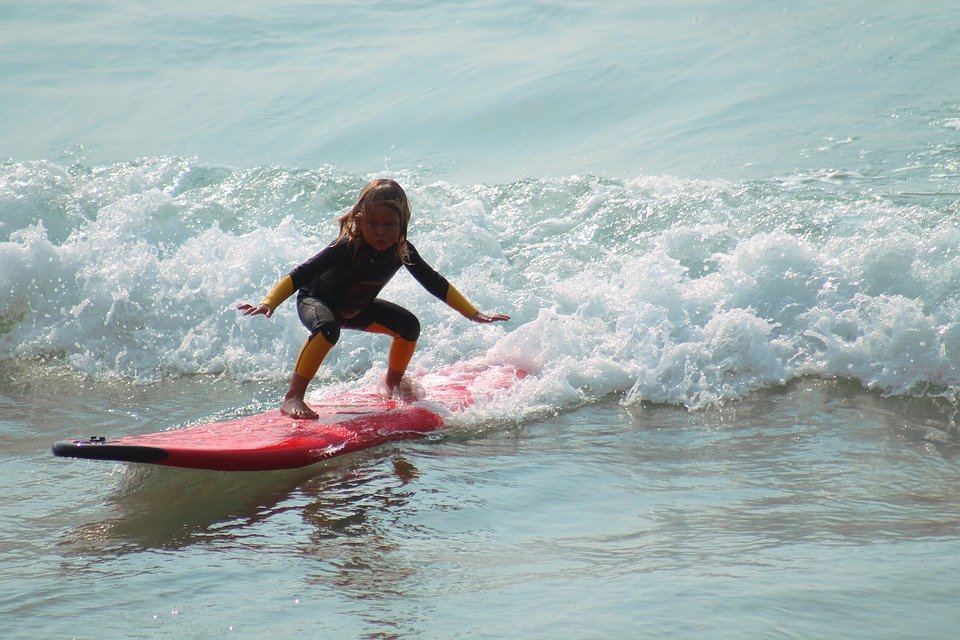 Child learning to surf