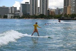 Man on surfboard in low surf