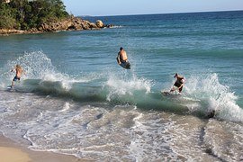 Three surfers in the whitewater